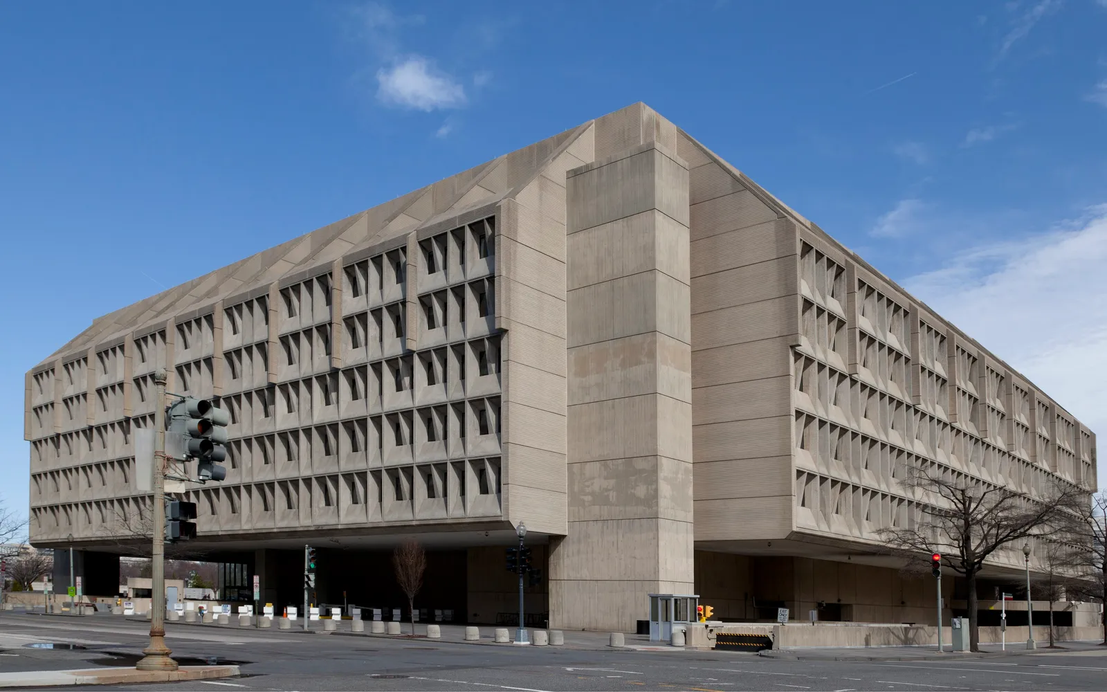 The concrete Hubert H. Humphrey Building, headquarters of the U.S. Department of Health and Human Services, under a blue sky