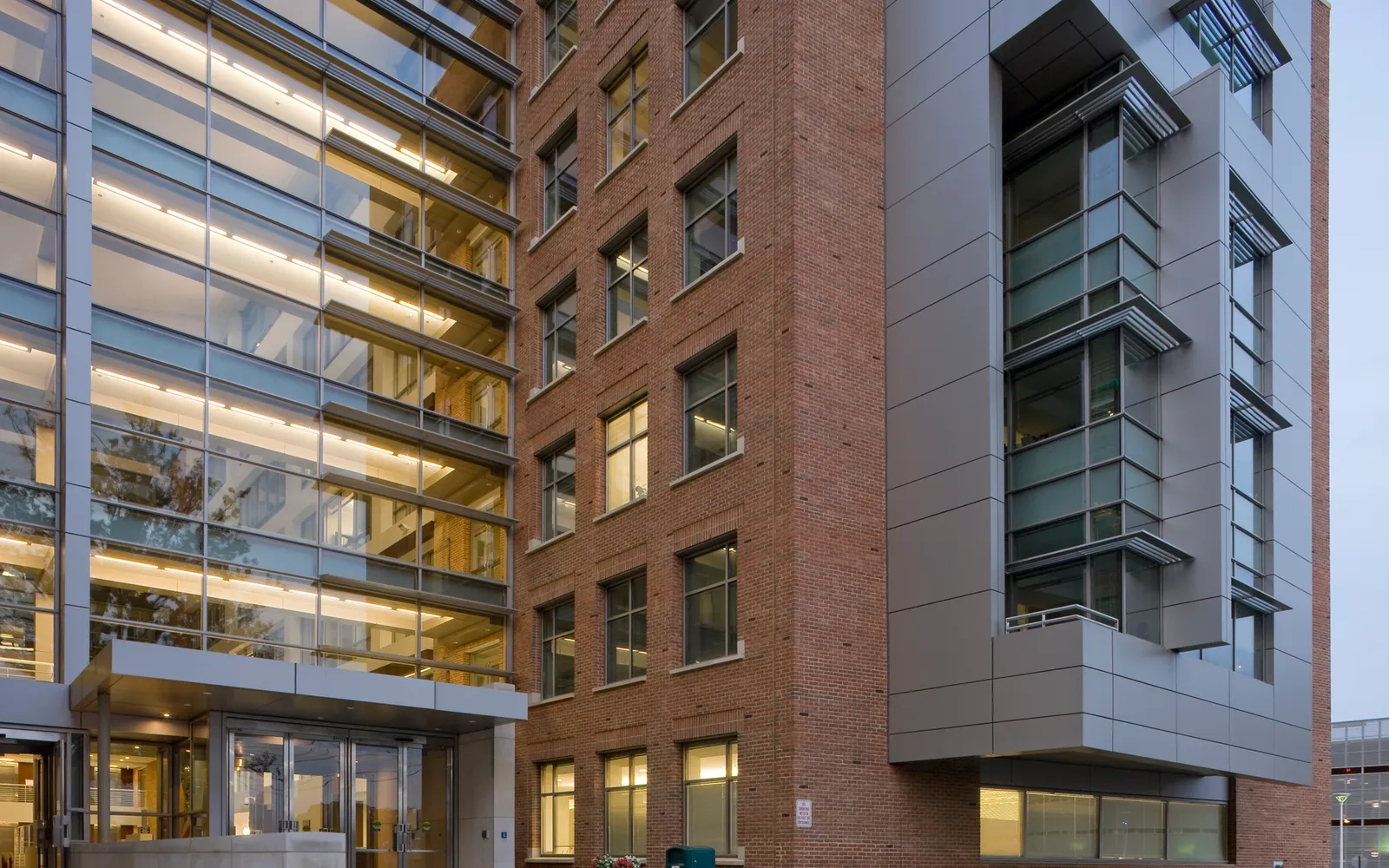 The glass and brick entrance of FDA Building 51, home of the agency's drug center, lit at dusk