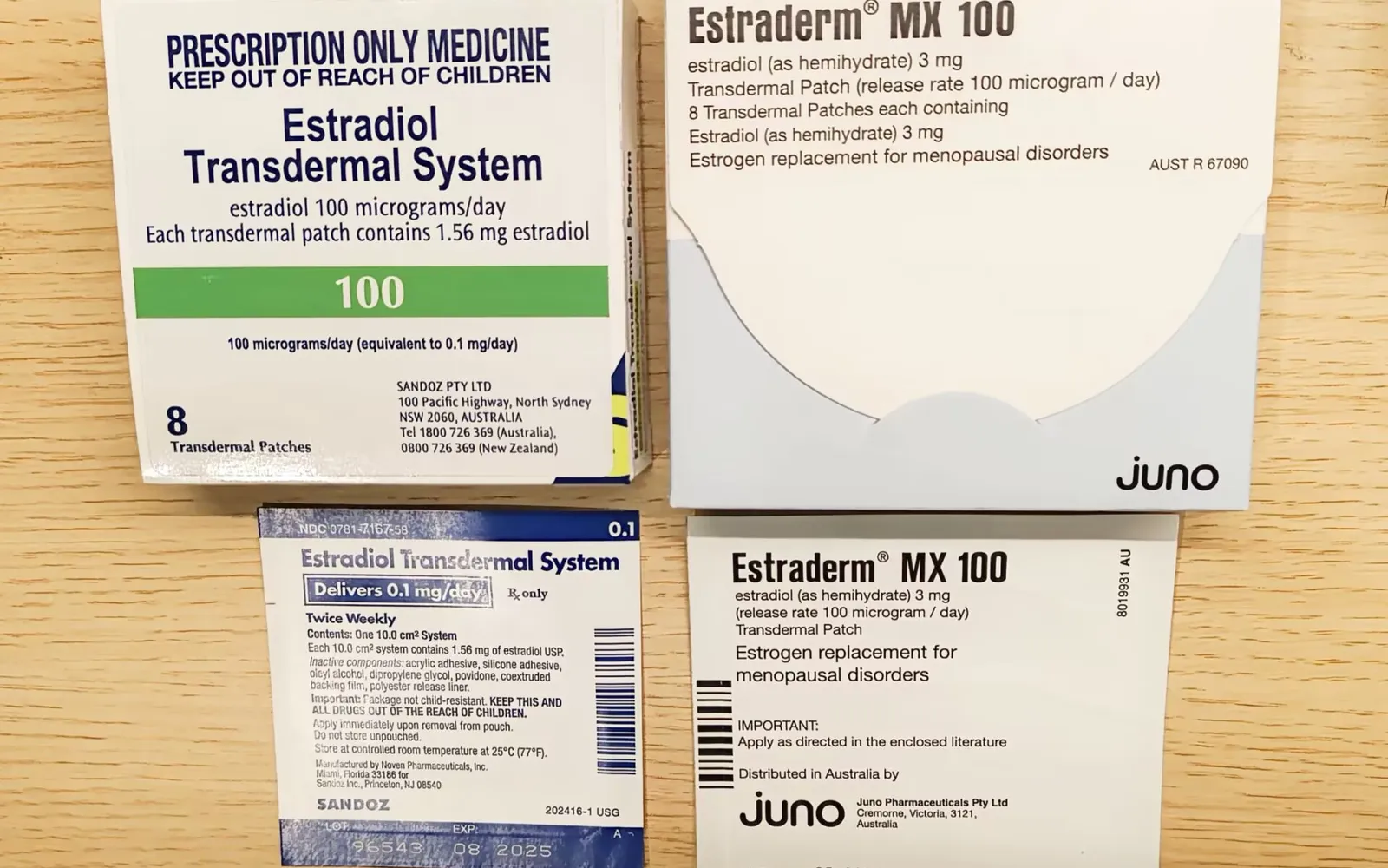 Boxes and pouches of estradiol transdermal patches, labeled for menopause, on a wooden desk
