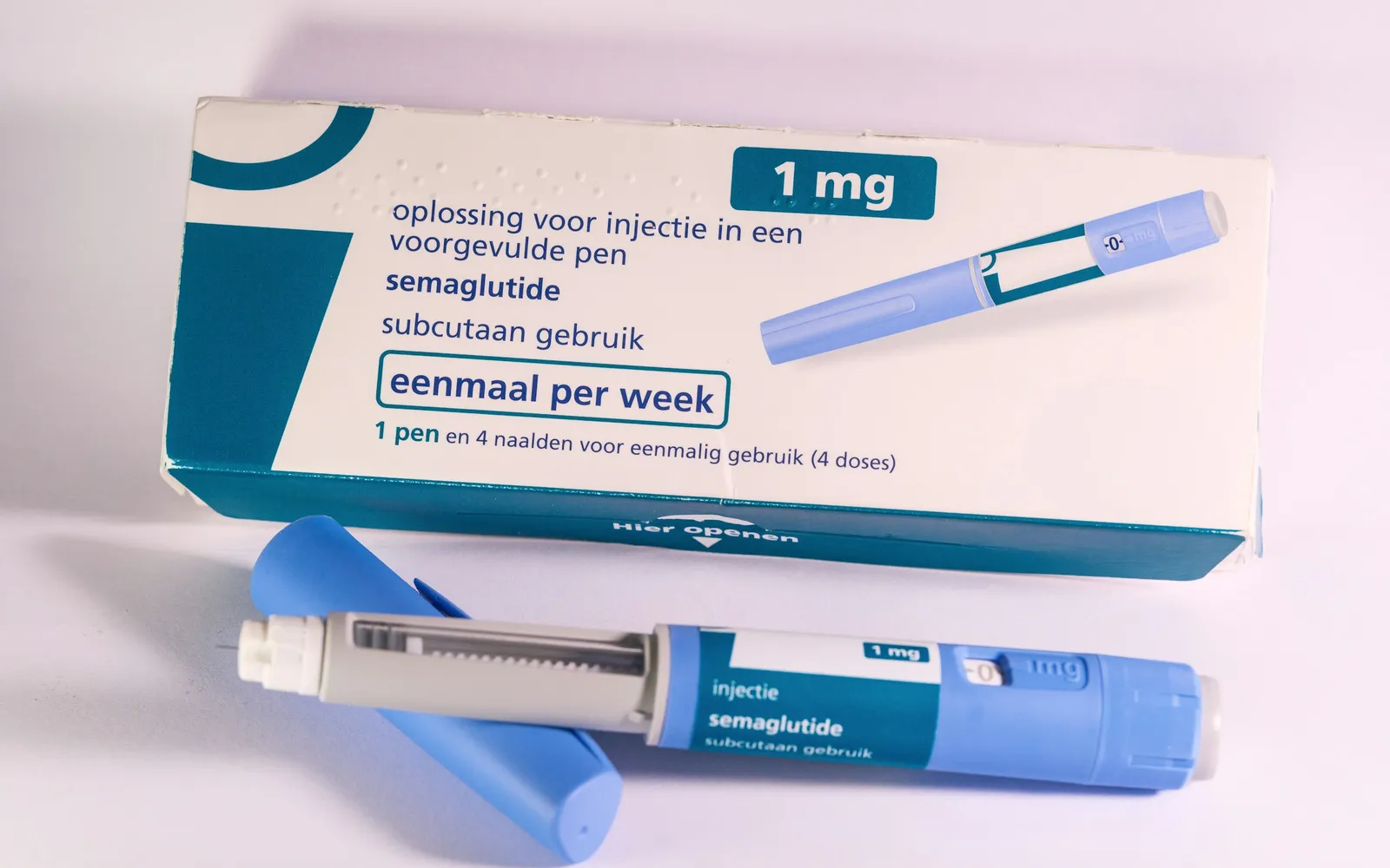 A generic semaglutide medicine box and injection pens on a plain surface, with no brand name visible