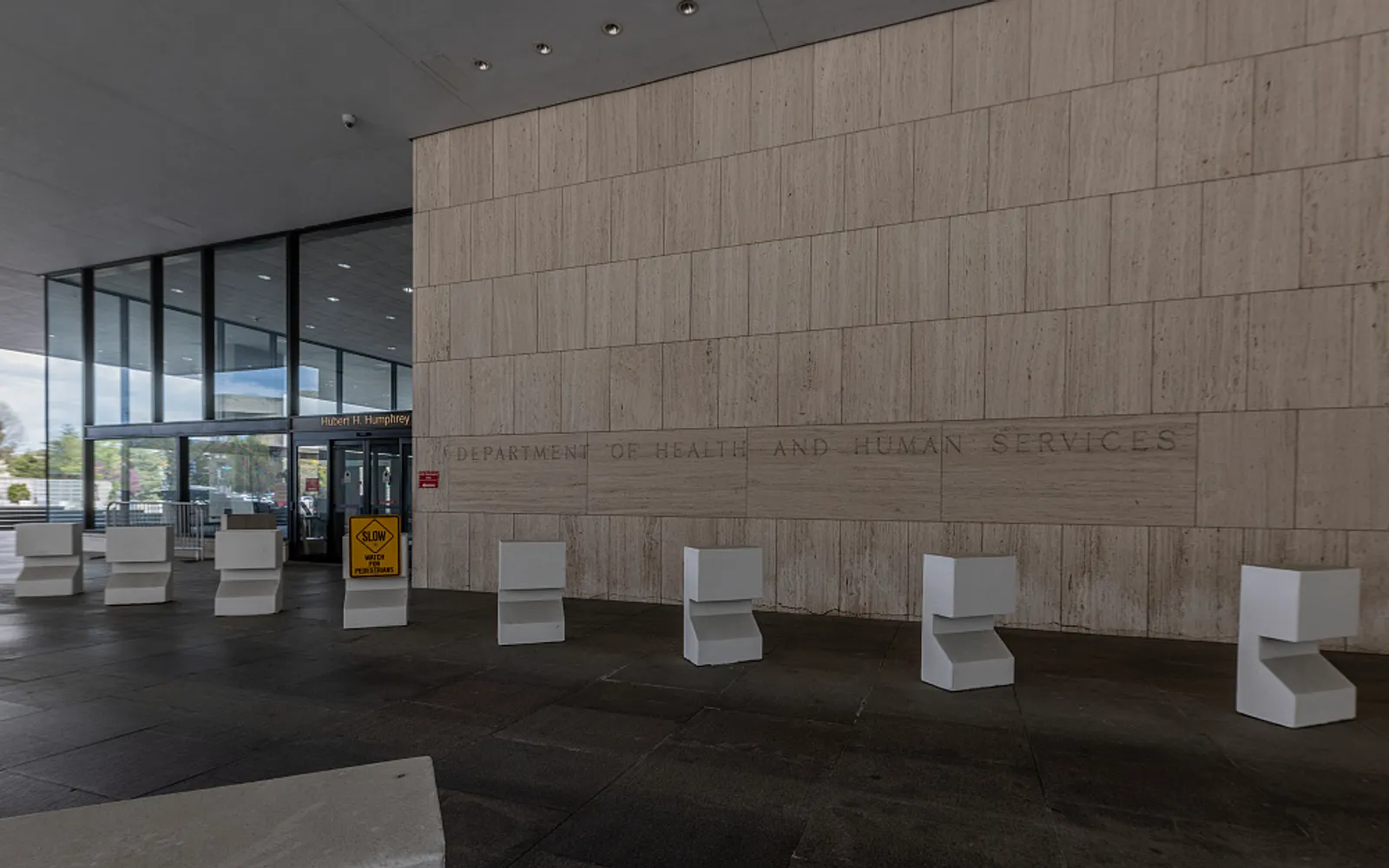 The stone wall of the U.S. Department of Health and Human Services headquarters with the department name carved in it