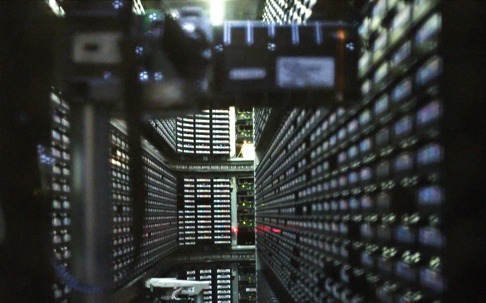 Rows of data storage tape cartridges inside a robotic tape library at a national lab computing center